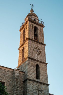 Evening sun on the bell tower of the church Sainte Mary de l'Assomption in the town of Sartene in Corsica clipart