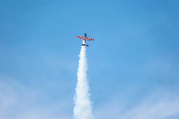 stock image Sarlat-Domme, Dordogne, France - 25th August 2024: An Extra 330LX in the livery of the French Armee de l'Air performs aerobatics at the Sarlat-Domme Spectacle Aerien airshow