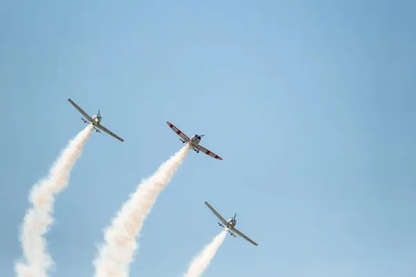 stock image Sarlat-Domme, Dordogne, France - 25th August 2024: Two Tecnam P220JF Sierras and a Mudry Cie CAP 10 B perform aerobatics at the Sarlat-Domme Spectacle Aerien airshow