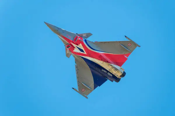 stock image Sarlat-Domme, Dordogne, France - 25th August 2024: The Rafale Solo Display in the livery of the 90th anniversary of the French Armee de l'Air & de l'Espace performs aerobatics at the Sarlat-Domme Spectacle Aerien airshow