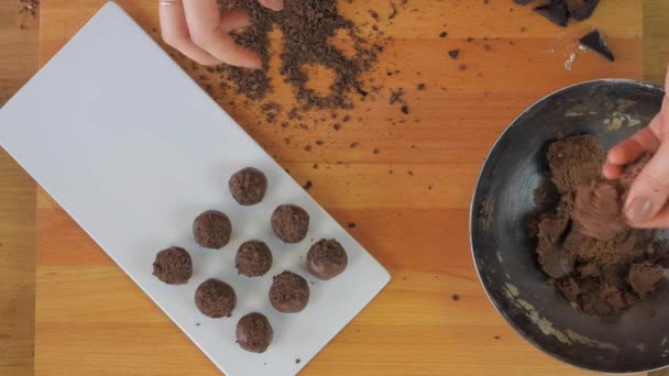 Woman Rolls Sweet Cocoa Dough Her Hands Makes Small Balls — Stock Video