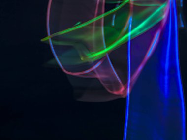 Karanlık arka planda renkli ışık izleri. Parlak renklerde dönen soyut ışık yolları. Işık resminin bulanık hareketinin ormanları. Geceleri bulanık ışıklar. Kasıtlı kamera hareketi, ICM sahnesi