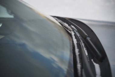 windshield wipers covered with snow