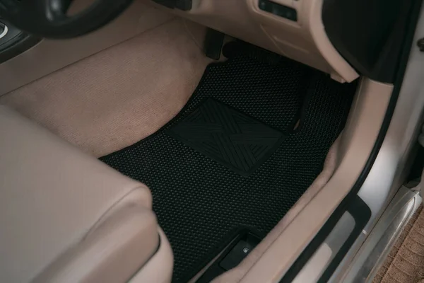 Car interior with honeycomb vinyl floor mat.