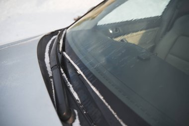 windshield wipers covered with snow
