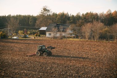 Tractor on the field during a sunny day.
