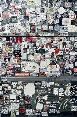 Hamburg, Germany, Europe 25.12.2022. The street wall is covered with numerous multicolored stickers. Horizontal photo.