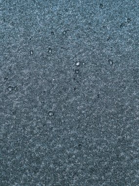 Macro of car glass window covered with ice and snow. Concept of bad visibility during freezing weather conditions.