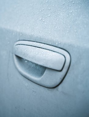 Frosted ice car door handle covered with ice crystals. the iced vehicle handle. Concept of a frosty morning