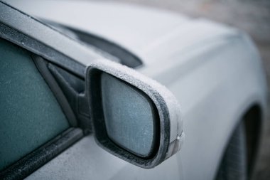 side view mirror covered with hoarfrost. frosty morning