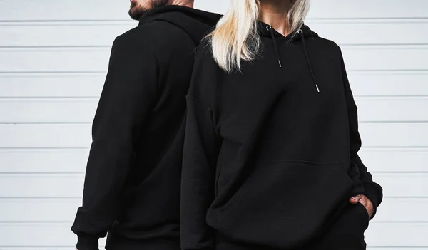 Design mock-up for clothing logo. Man and woman wear a basic hoodie. No logo street wear brand design.