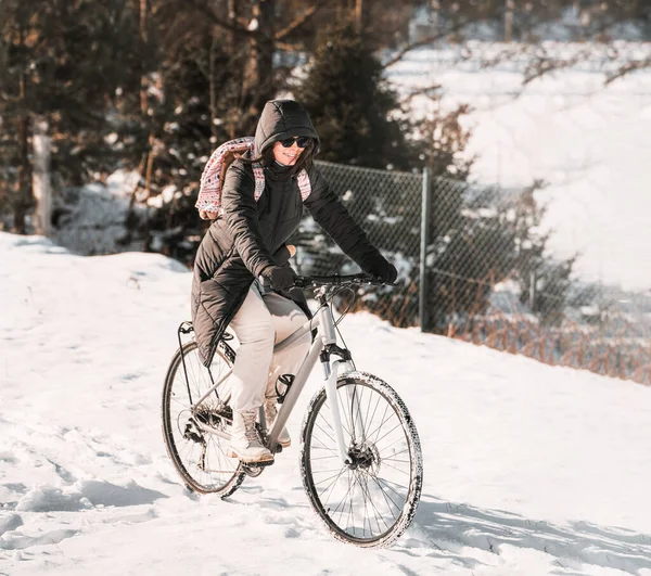 stock image Portrait of a woman riding a bicycle in winter.