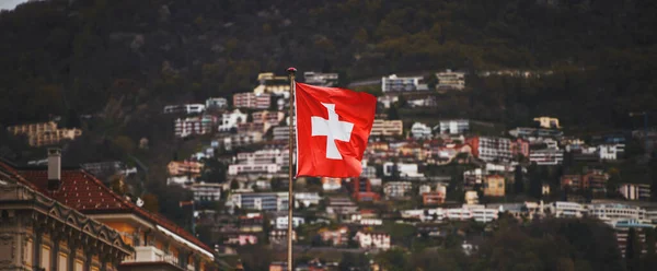 Flag of Switzerland. A red flag with a white cross on it. Swiss flag.