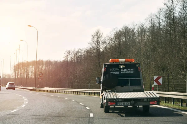 stock image 27.04.2023 Germany, Europe. Empty flatbed tow carrier truck. empty car carrier and flatbed tow truck vehicle travelling on a national road