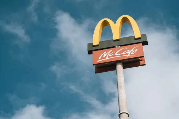 stock image 14.04.2023 Poland, Europe. Mcdonalds logo in the sky of the highway. Fast food company advertisement on a signpost.