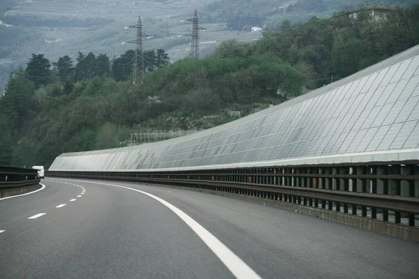 Solar Highway is a noise barrier along the motorway. Solar modules along highways in Europe. Concept of sustainable future.
