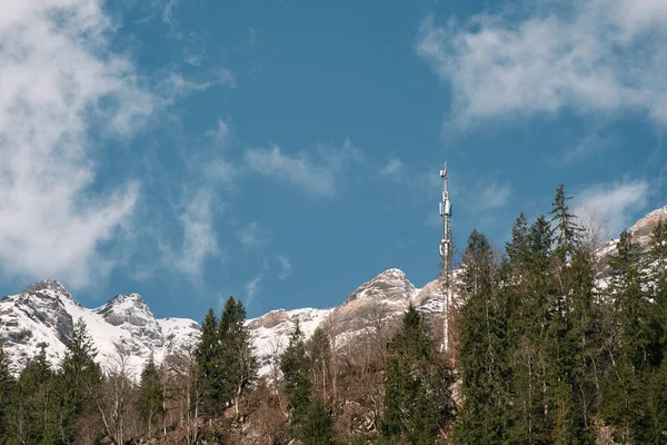 Telecom Tower 5G and 4G Cellular Networks in the sky. cell tower over a forested rural area