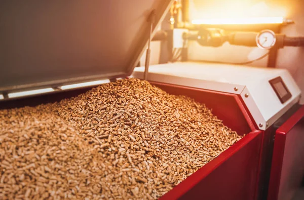 stock image Wood pellets heating stove. Boiler room in private household working on alternative energy biofuel. Sustainable Future Concept