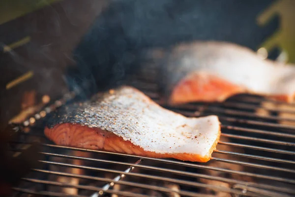 stock image salmon fillet on the grill with flames. outdoor backyard grill time concept. healthy food