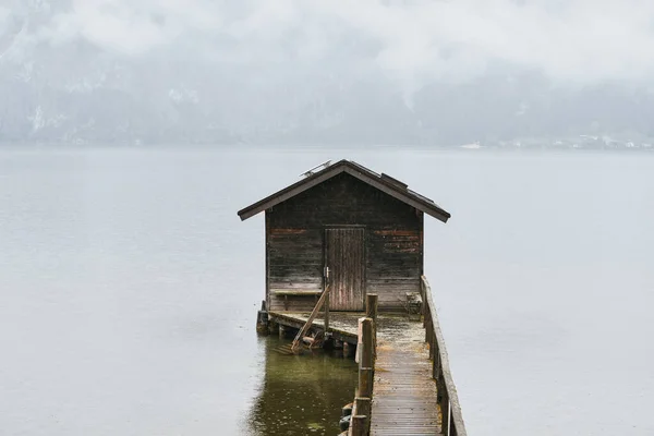 wooden house on the lake in the Austrian Alps. house on the shores of a mountain lake. Alpine house in the high beautiful mountains.