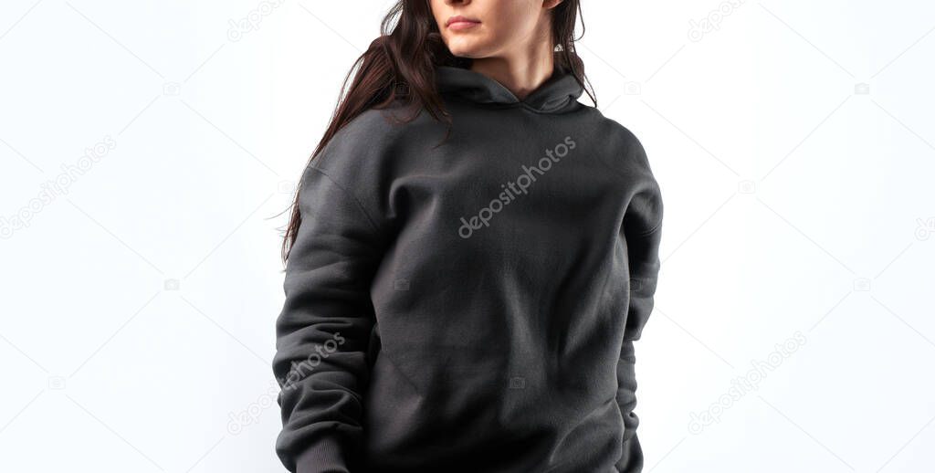 Woman wears a black hoodie mock-up. Streetwear clothing branding. Logo on shirt template copy space.