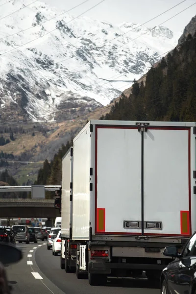 Cargo truck on the mountain highway. Delivery truck on the Europe motorway.