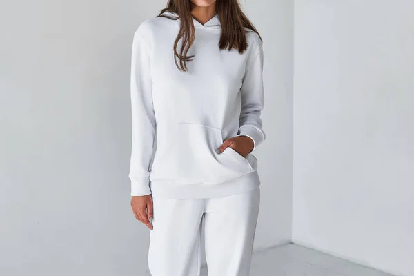 Woman Showcasing a white Hoodie for Logo Branding. Streetwear clothing mock-up. Logo on shirt template copy space.