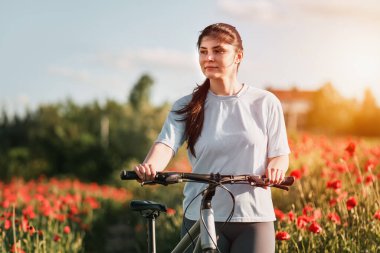 First-person view of handling the bicycle on the forest road in the city towards sunlight. Concept of using a bicycle for sports and recreation out of a town.