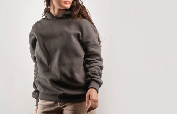 Clothes mockup for logo and branding. Close-up of woman wears a plain hoodie. Space for logo street wear.