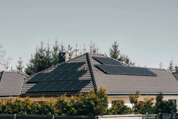 Sustainable Living Future. Modern Black Solar Panels Powering a Private House with Renewable Energy. Renewable energy for the home concept.