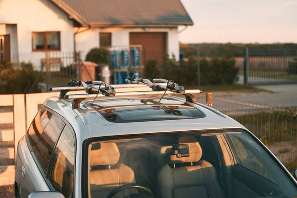 Versatile Roof Rack for Station Wagons: Safely Transporting Sports Equipment and Big Items. A roof rack or bar on a station wagon or estate car. Transportation of sports equipment in the family car.