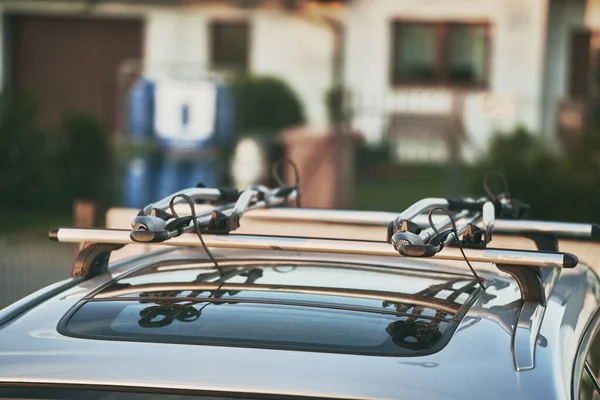 A roof rack or bar on a station wagon or estate car. Transportation of sports equipment and big items. Anti-Theft protection