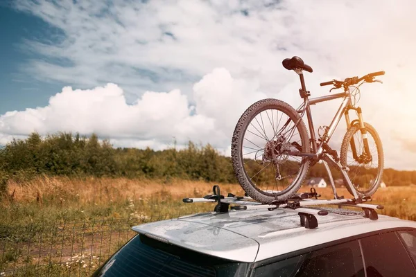 Outdoor Adventure Awaits. Family Car with Bicycles Mounted on Roof Rack. A vehicle with top mounted bikes.
