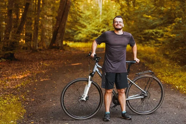 Outdoor Adventure. Man Enjoying Mountain Biking in Natural Landscape. Countryside Cycling. Young Male Biker on a Mountain Bike