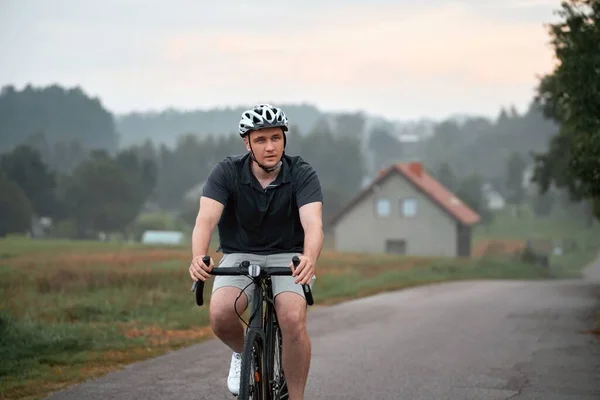 Man rides a bicycle. Into the Wilderness. Cycling Adventure in the Forest