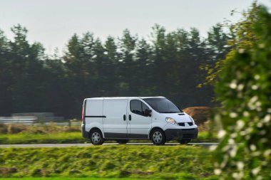 Teslimat güzergahında. Yoldaki ticari minibüs kapanışı. Lojistik marka. Ticari minibüs yolda. Son varış yeri nakliye kamyonu modeli.