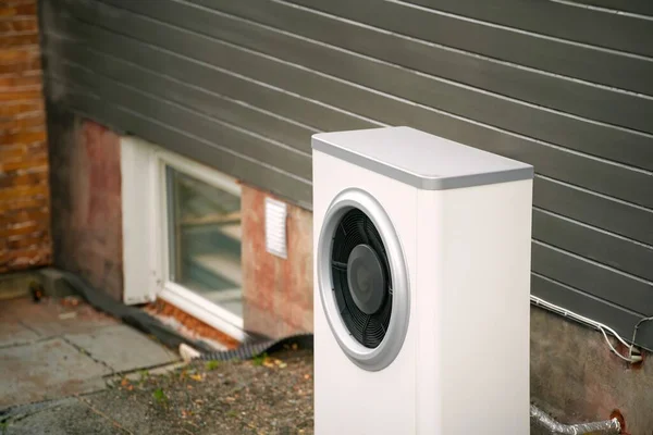 A heat pump system that cools and heats a house, with an air conditioner outdoor. An outdoor unit of an air conditioner installed near a house