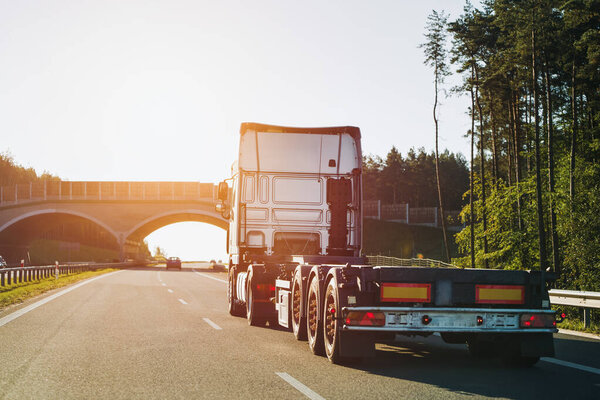 Cargo truck on the mountain highway. Delivery truck on the Europe motorway. Global delivery concept.