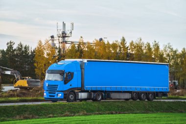 Otobanda gün batımının dramatik ışığıyla Avrupa kamyon aracının ön görüntüsü. Kargo taşıma ve tedarik kavramı. Güzel gün batımı ışığında otoyolda yüklü bir Avrupa kamyonu.