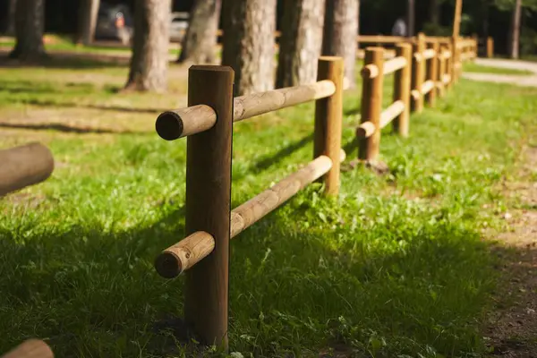 Wooden fence barrier at farm grounds for cattle and territory protection