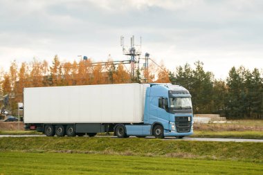 Otobanda gün batımının dramatik ışığıyla Avrupa kamyon aracının ön görüntüsü. Kargo taşıma ve tedarik kavramı. Güzel gün batımı ışığında otoyolda yüklü bir Avrupa kamyonu.