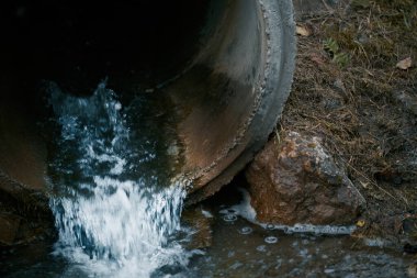 Atık su kanalizasyonu bir borudan nehre akar. Kirlilikle mücadele. Atık su ve nehir ekolojisini yönetiyorum. Kötü koku zehirli su.