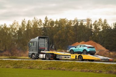 Bir çekici kötü havada otoyolda bozuk bir araba taşır. Yol yardımı, başı dertte olan bir sürücüye yardım eder. Geri çekilme kamyonu.