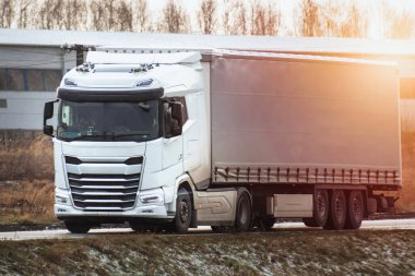 A truck transports cargo containers transported on land with semi trailers. Highway shipping and post delivery. Global commerce and industry that uses sustainable efficient logistics systems.