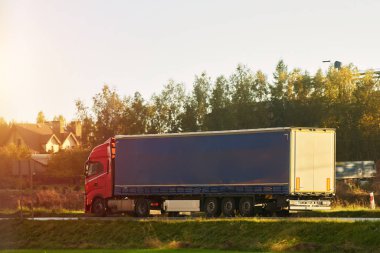 Modern white trucks with semi-trailers drive on a highway. Transporting cargo containers for commercial and industrial purposes. Sustainable logistics and efficient delivery methods to ship goods.
