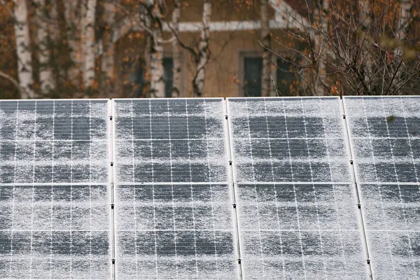 Solar panels are covered with snow in winter. Photovoltaic electricity installation during the winter season. Efficient and Safe Energy Generation with Photovoltaic Technology.