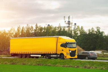 A truck transports cargo containers transported on land with semi trailers. Highway shipping and post delivery. Global commerce and industry that uses sustainable efficient logistics systems.