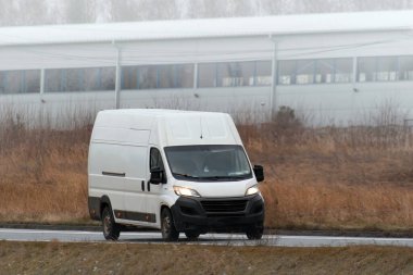 Marka ve teslimat hizmetiniz için beyaz bir minibüs. Yoldaki ticari bir aracın izole edilmiş bir maketi..