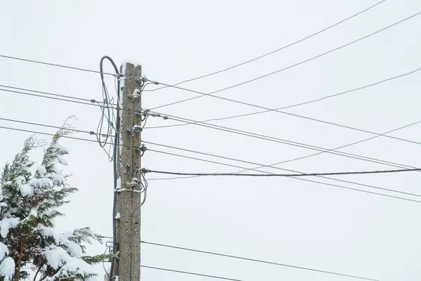 Electricity and snow. electric wires and pylons that are frosted with snow. nature and technology in winter.