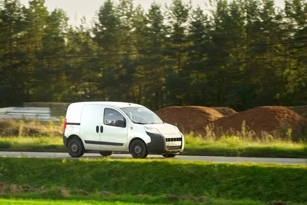delivery van. A mockup of a white commercial vehicle isolated on the road. Perfect for your business and shipping needs.